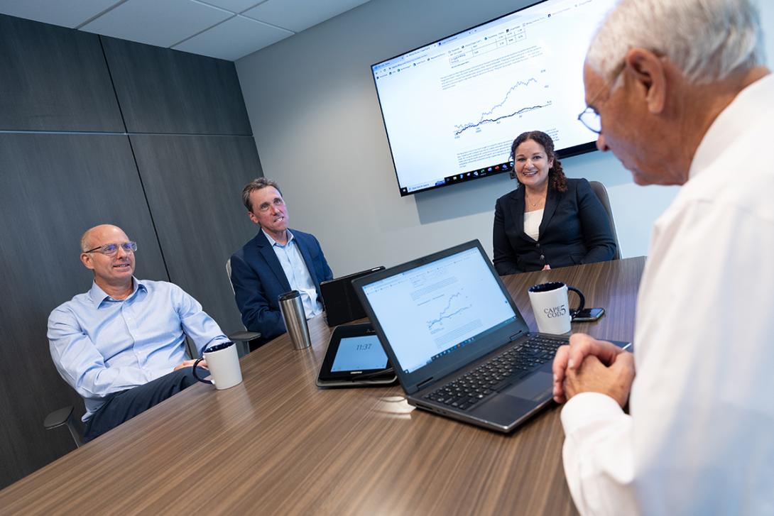 Four members of the Cape Cod 5 Wealth Management team meeting in conference room